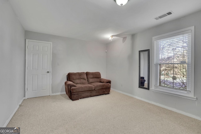 sitting room with baseboards, visible vents, and carpet flooring