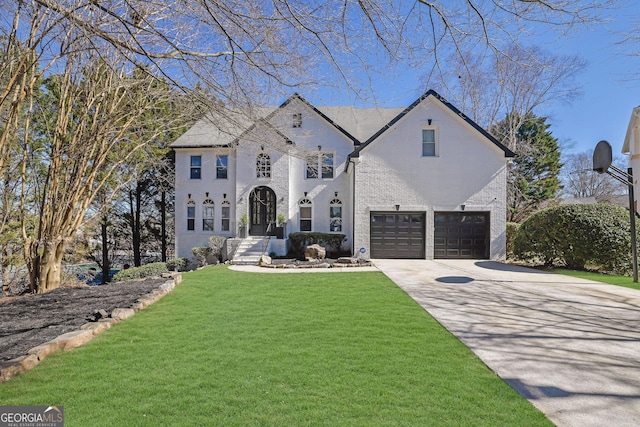 french country home featuring concrete driveway, a front lawn, and an attached garage