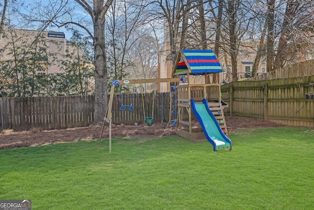 view of playground featuring a fenced backyard and a lawn