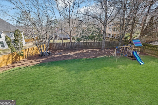 view of yard featuring a fenced backyard and a playground