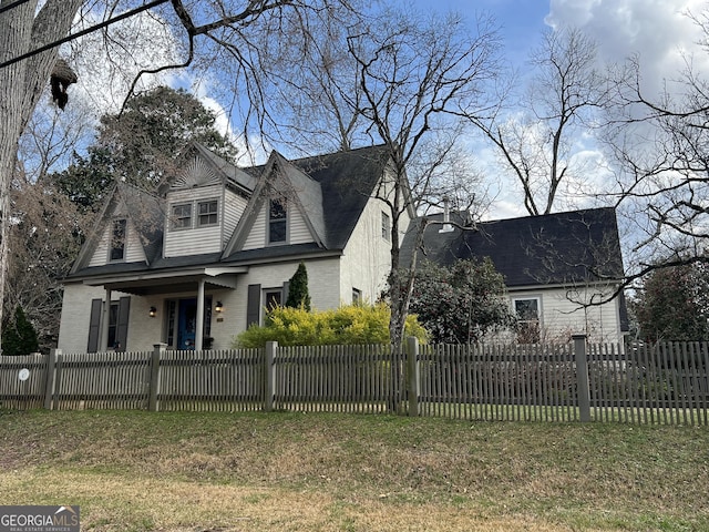 view of front facade with a fenced front yard and brick siding