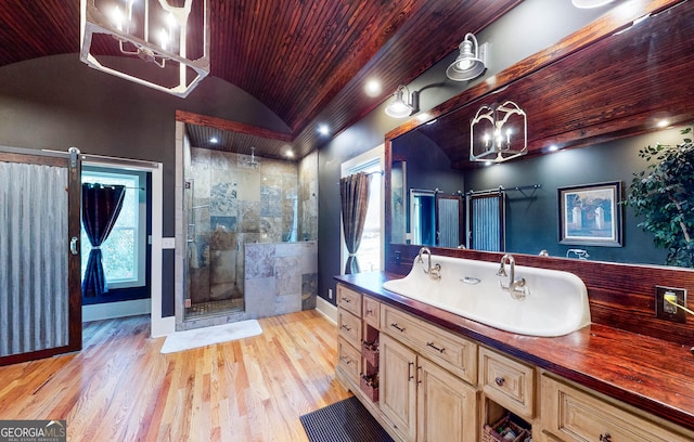 full bathroom featuring baseboards, lofted ceiling, wood ceiling, wood finished floors, and a tile shower