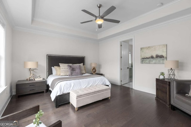 bedroom featuring crown molding, baseboards, a tray ceiling, wood finished floors, and a ceiling fan