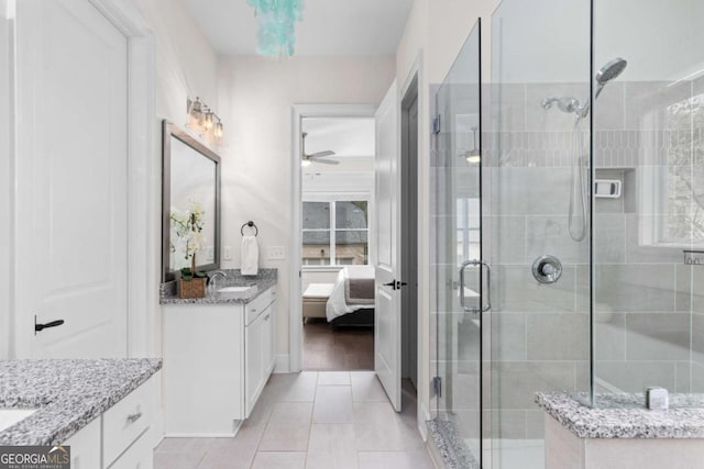 full bathroom with ensuite bath, a stall shower, vanity, and a ceiling fan