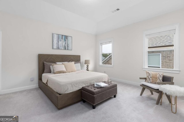 bedroom featuring baseboards, visible vents, and light carpet