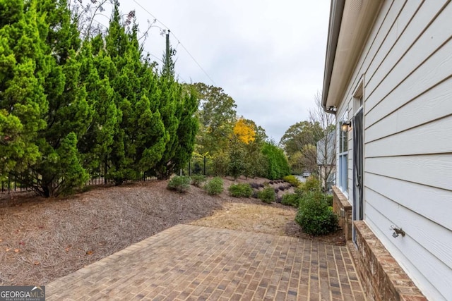 view of yard featuring a patio and fence