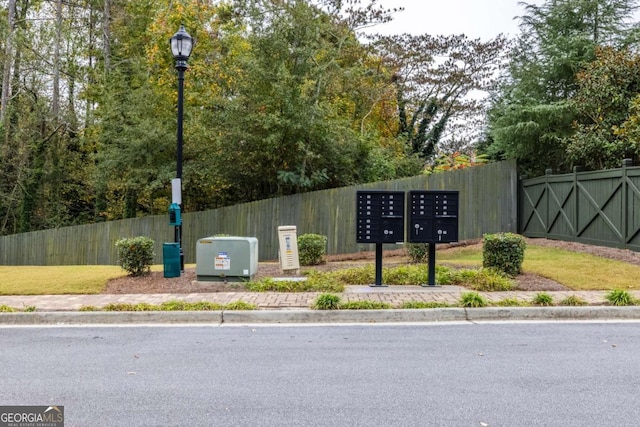 view of property's community with mail area and fence