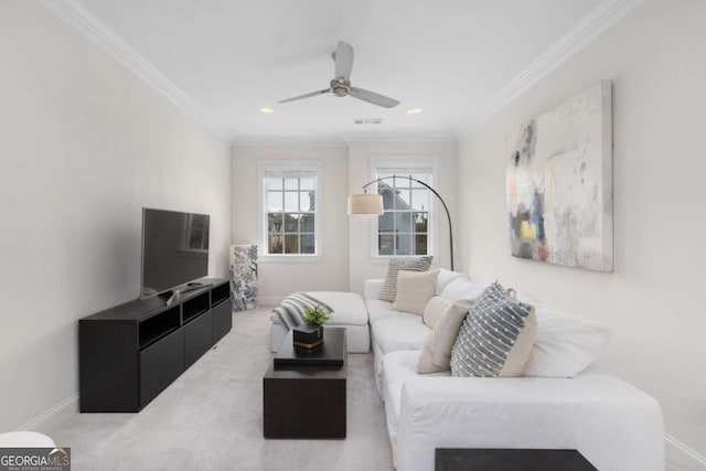 carpeted living area with ceiling fan, visible vents, baseboards, and ornamental molding