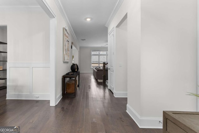 hallway featuring dark wood-style floors, baseboards, and ornamental molding