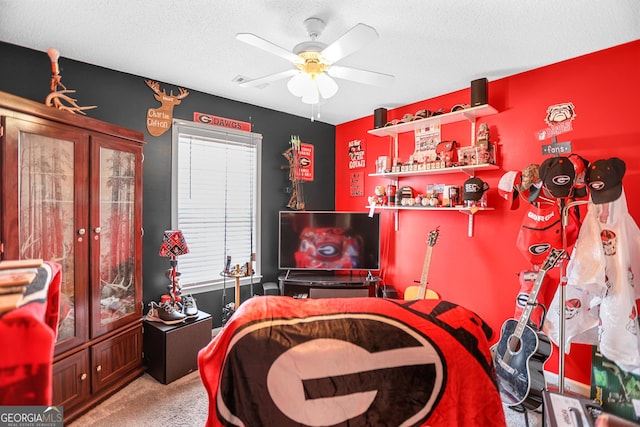 bedroom with carpet floors, ceiling fan, and a textured ceiling