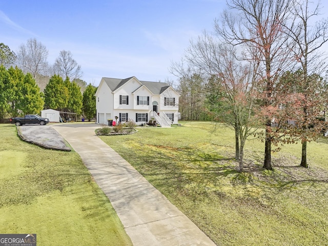 view of front of house with concrete driveway, an attached garage, an outdoor structure, a front lawn, and stairs