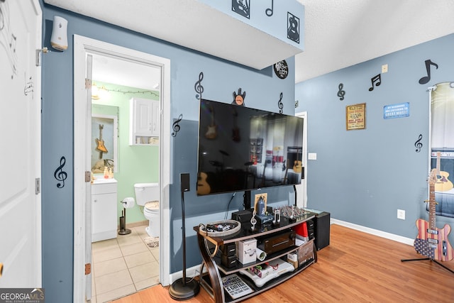 living room with baseboards and wood finished floors