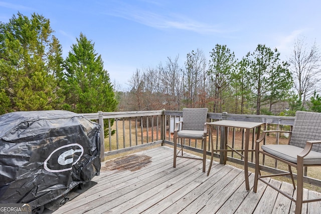 wooden terrace featuring a grill