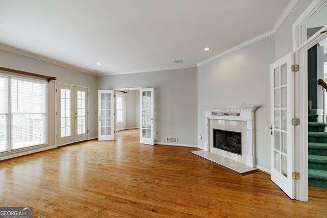 unfurnished bedroom featuring recessed lighting, crown molding, baseboards, and wood finished floors