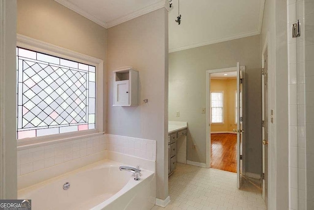 bathroom with vanity, baseboards, a bath, tile patterned floors, and crown molding