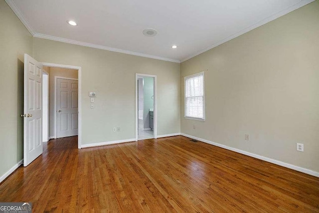 unfurnished bedroom with recessed lighting, wood finished floors, crown molding, and baseboards