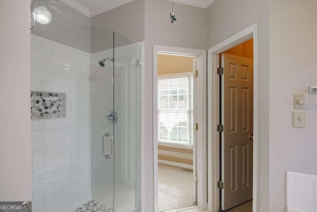 full bathroom with a shower stall and crown molding