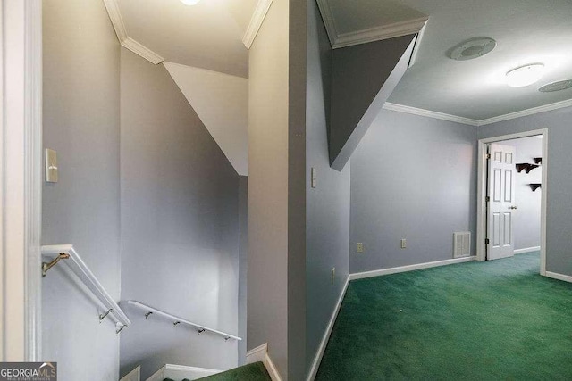 hall featuring visible vents, carpet flooring, ornamental molding, and an upstairs landing