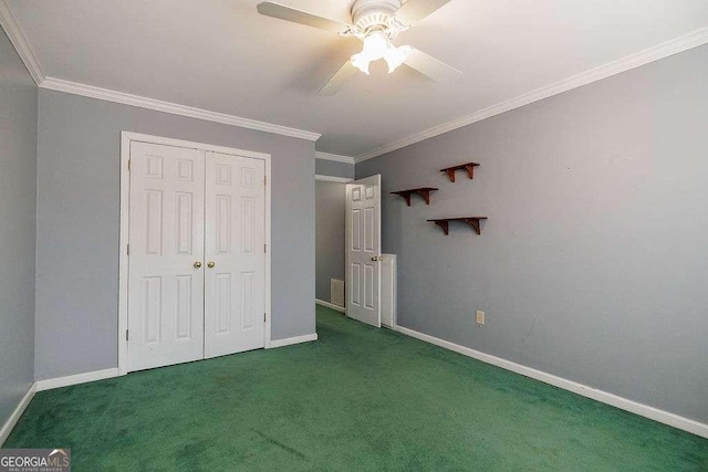 unfurnished bedroom with baseboards, carpet floors, and crown molding