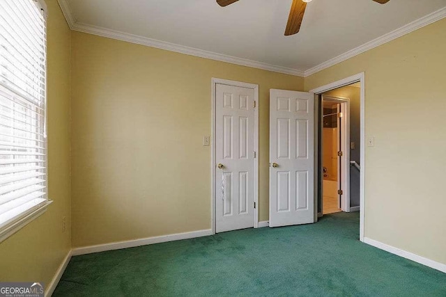 unfurnished bedroom with ceiling fan, baseboards, crown molding, and carpet flooring