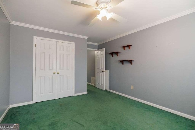 unfurnished bedroom with baseboards, a ceiling fan, a closet, carpet floors, and ornamental molding