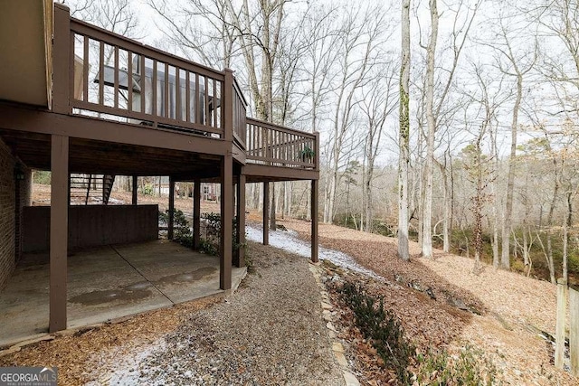 view of yard featuring a patio, a deck, and stairs