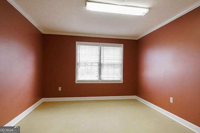 unfurnished room with concrete floors, a textured ceiling, baseboards, and ornamental molding