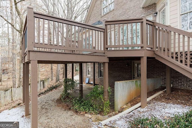 rear view of property with a wooden deck and brick siding