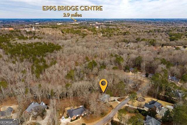 birds eye view of property featuring a view of trees