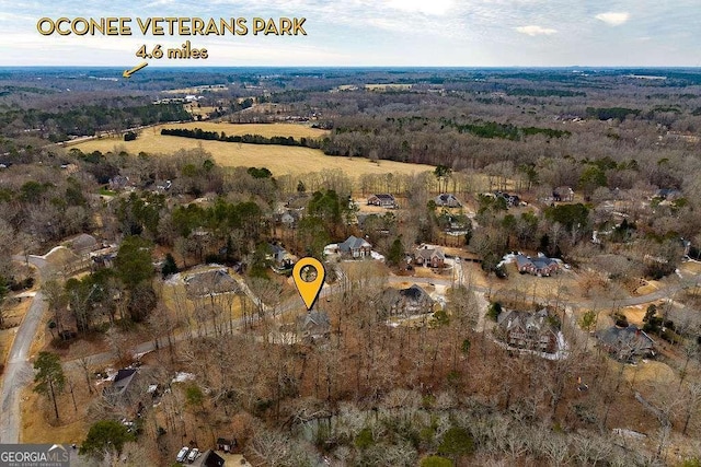 birds eye view of property with a view of trees