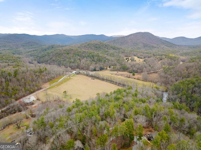 aerial view with a mountain view and a forest view