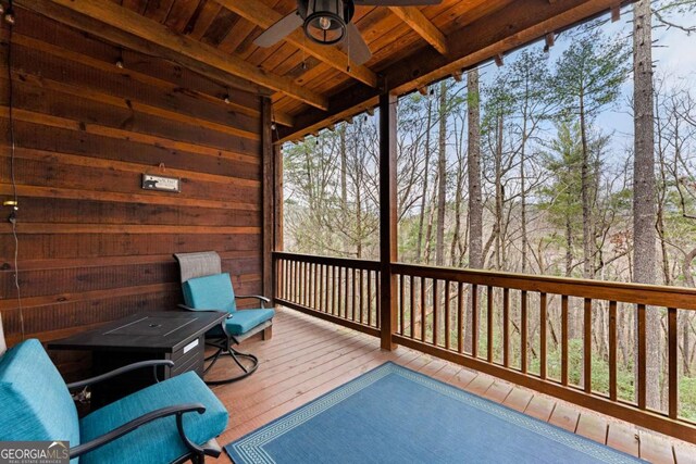 wooden deck featuring ceiling fan