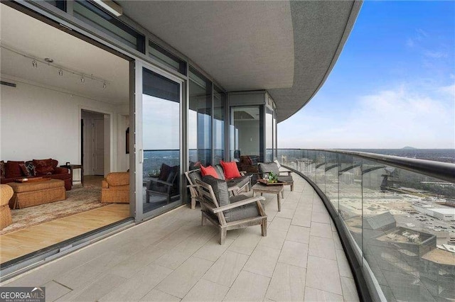 balcony with a sunroom and visible vents