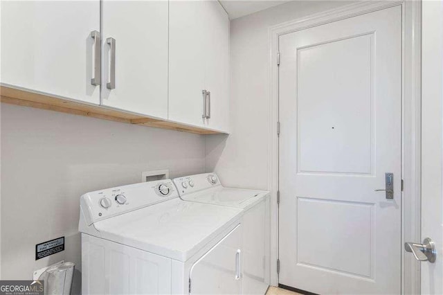 laundry area with washing machine and dryer and cabinet space