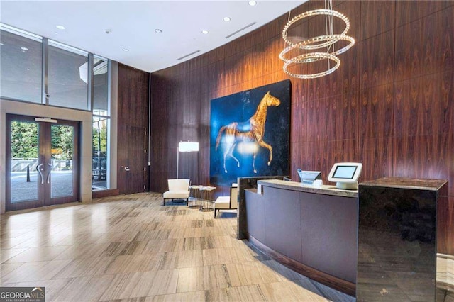 welcome area with visible vents, a chandelier, and french doors