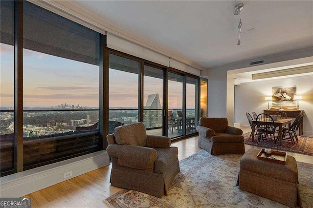 living room with visible vents and wood finished floors