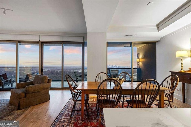 dining room with visible vents and wood finished floors