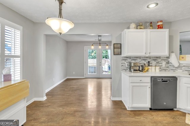 kitchen featuring tasteful backsplash, dishwasher, white cabinets, and light wood finished floors