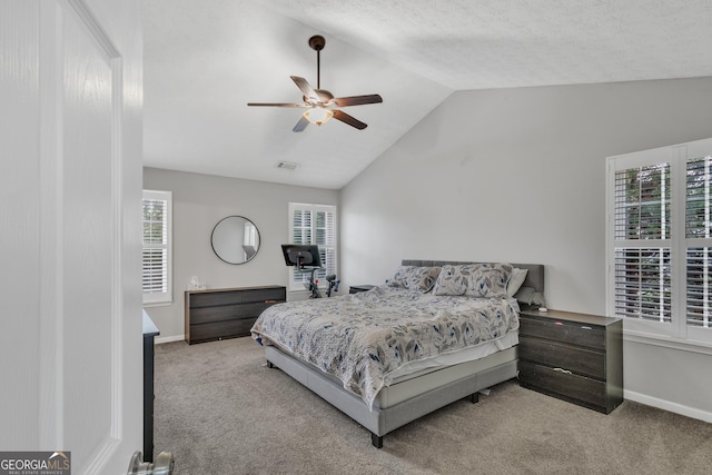 bedroom featuring visible vents, baseboards, carpet flooring, and vaulted ceiling