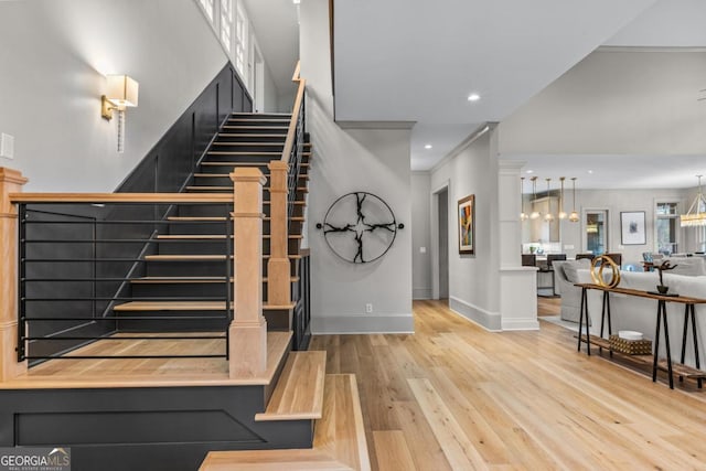 stairway featuring recessed lighting, baseboards, and wood finished floors