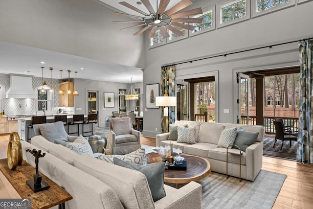 living area with a chandelier, light wood-style flooring, and recessed lighting