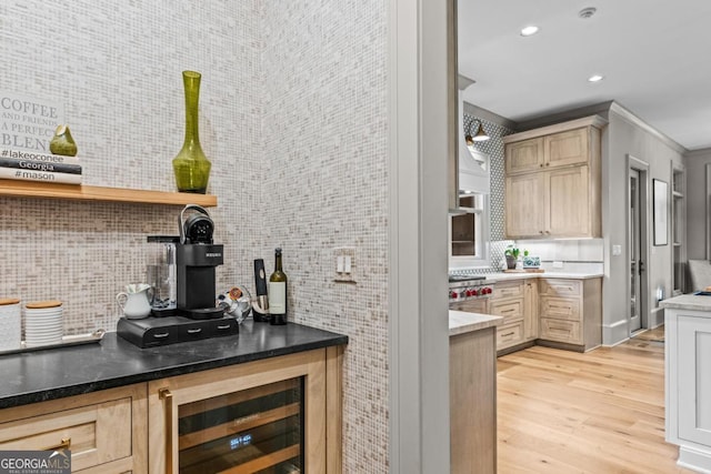 kitchen with wine cooler, recessed lighting, ornamental molding, backsplash, and light wood finished floors