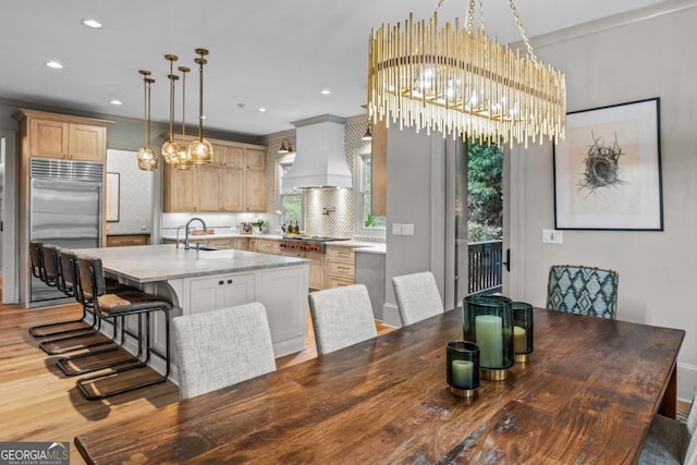 dining area featuring ornamental molding, recessed lighting, wood finished floors, and an inviting chandelier