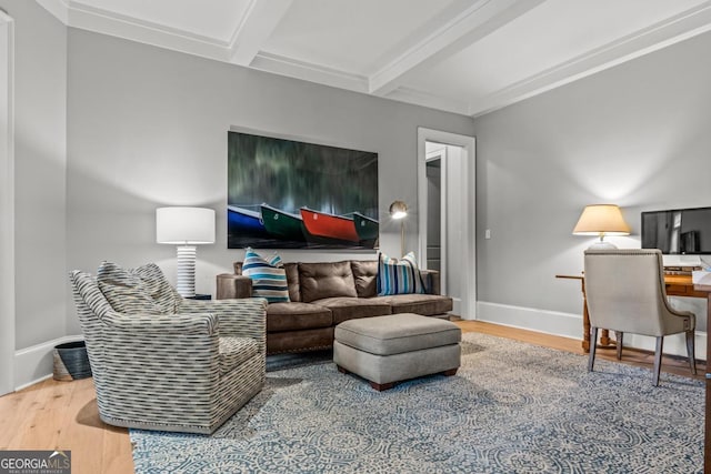 living area with baseboards, wood finished floors, and beamed ceiling