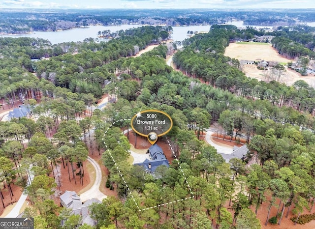 drone / aerial view featuring a water view and a view of trees