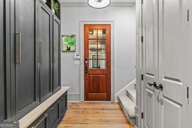 mudroom featuring light wood-type flooring and baseboards