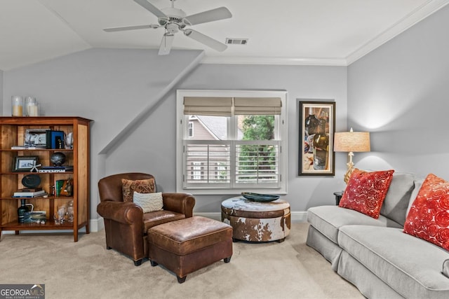 carpeted living room with ceiling fan, lofted ceiling, visible vents, baseboards, and crown molding