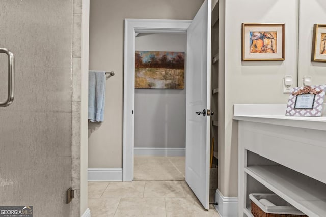 bathroom with tile patterned flooring and baseboards