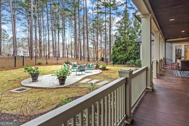 deck featuring a yard, a fenced backyard, and a patio