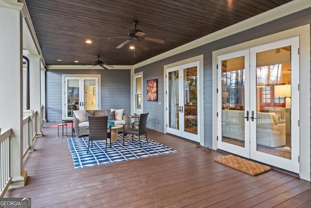 wooden terrace featuring ceiling fan, an outdoor living space, and french doors